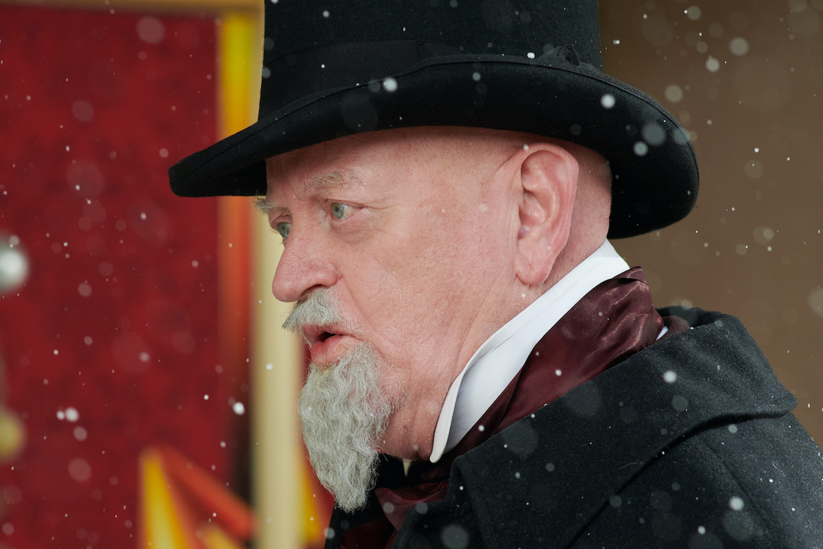 Cosplayer in tophat portraying Clement Clarke Moore in Hallmark movie still